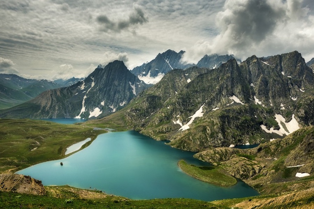 Group of great lakes on foot of hills in himalayan region in monsson season with grey clouds hovering over