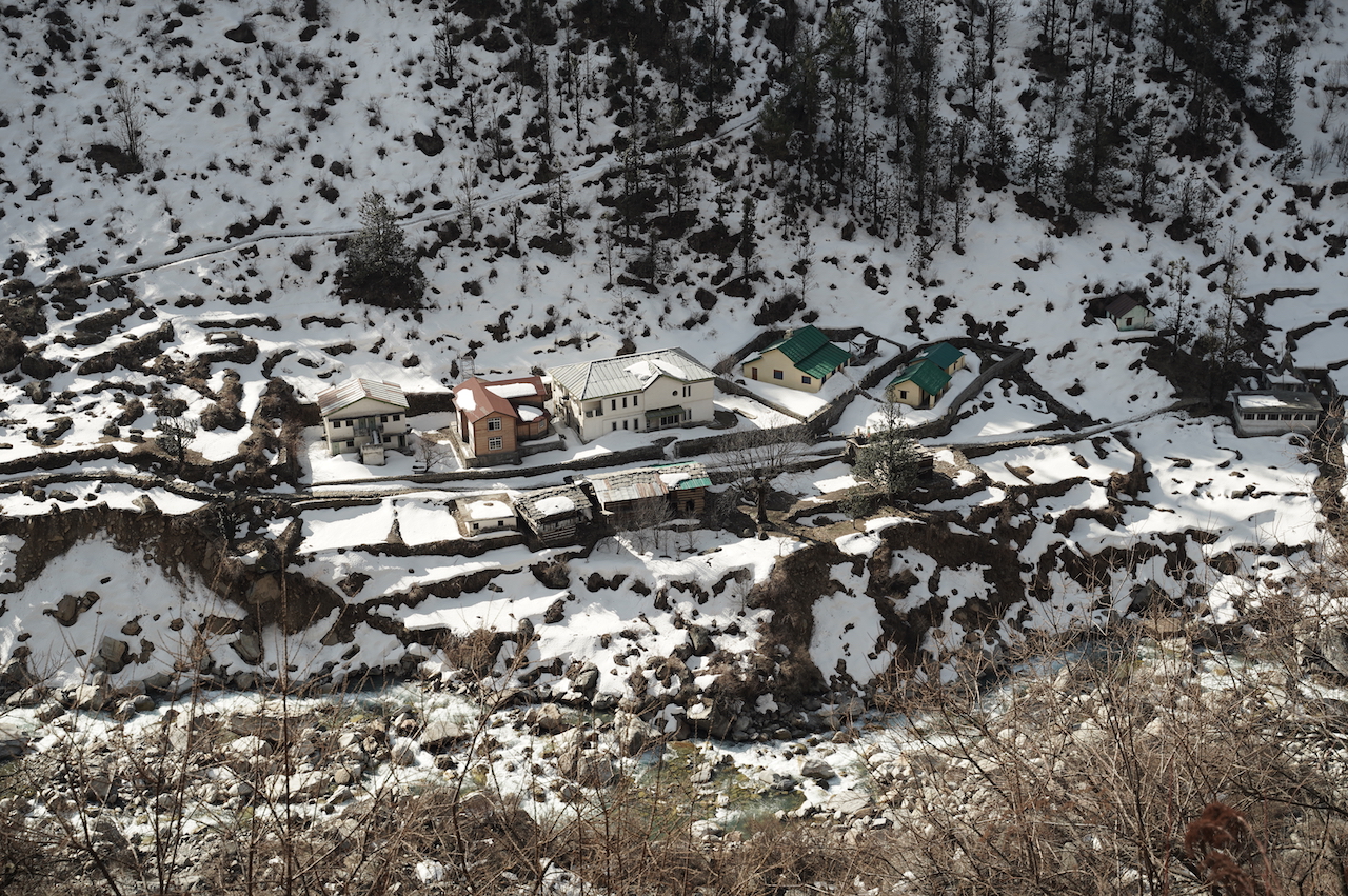 Sunlight shines on colourfull roof in snow covered houses of osla village 