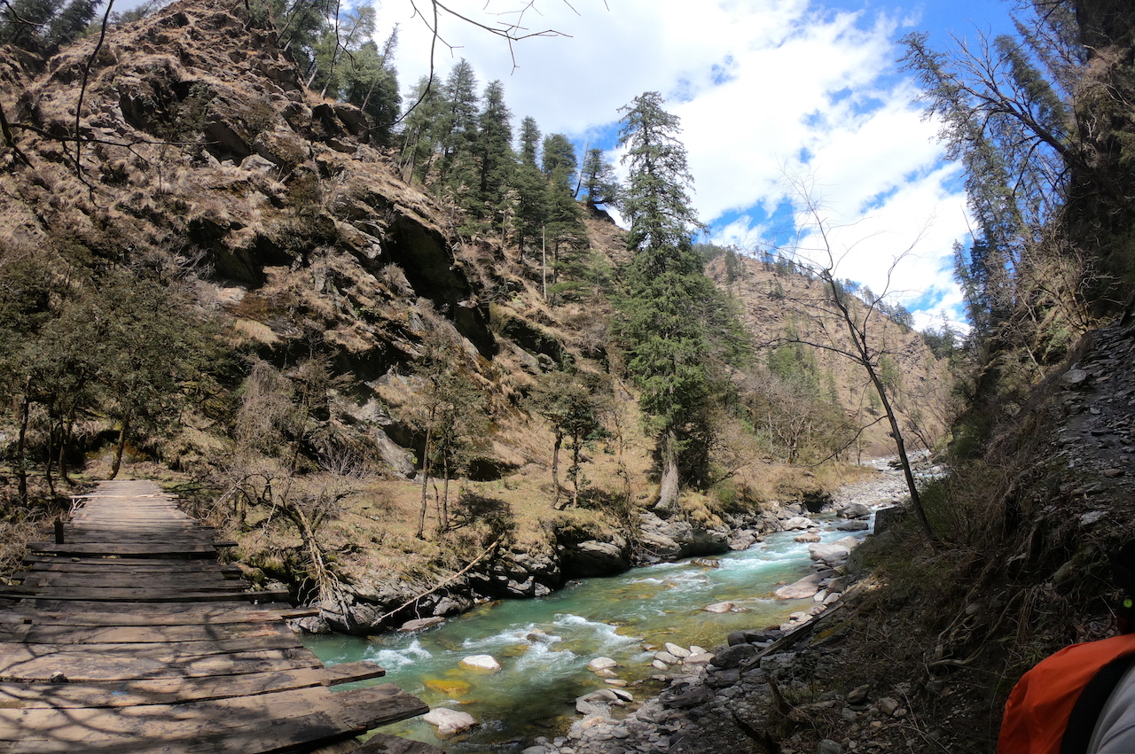 Wooden bridge connecting two mountains over supin river