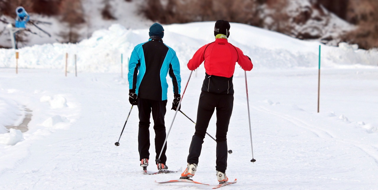  people wearing red and blue jacket skiing in snow