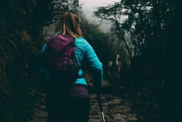 walking uphill using trekking poles