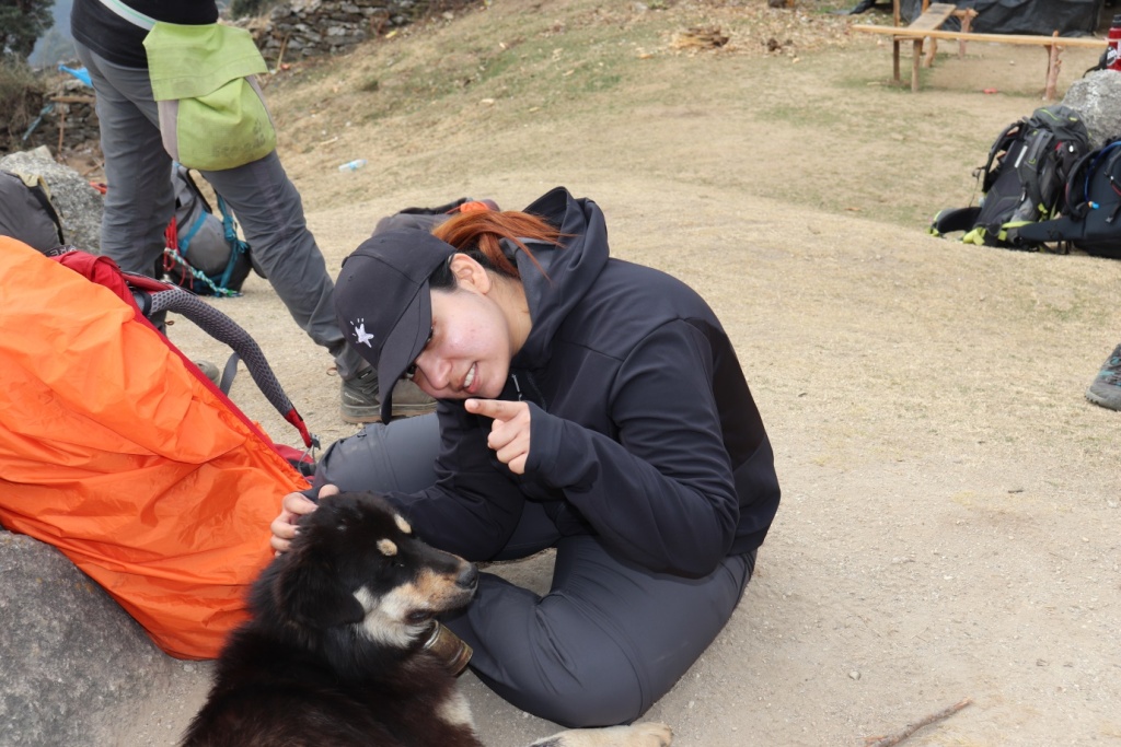 trekker with dog posing for camera