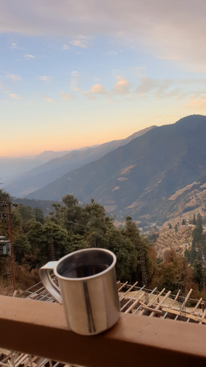 A coffee mug with mountains in the backdrop