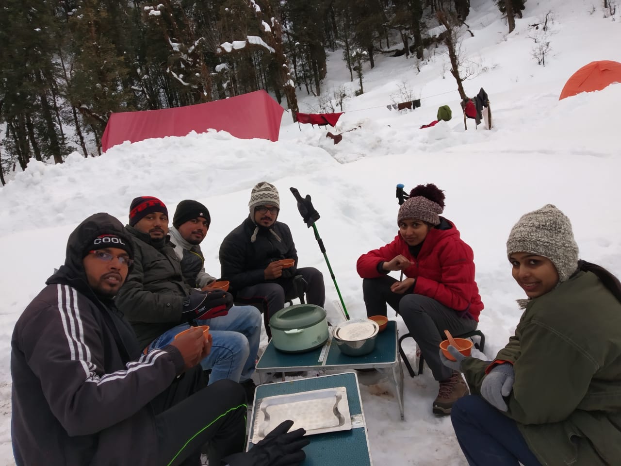 Trekkers having soup in a winter trek