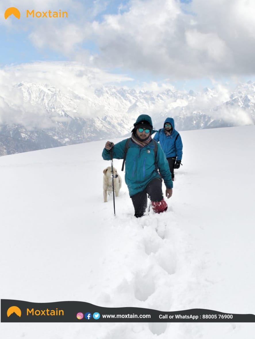 Winter trekking gears trekker in knee deep snow
