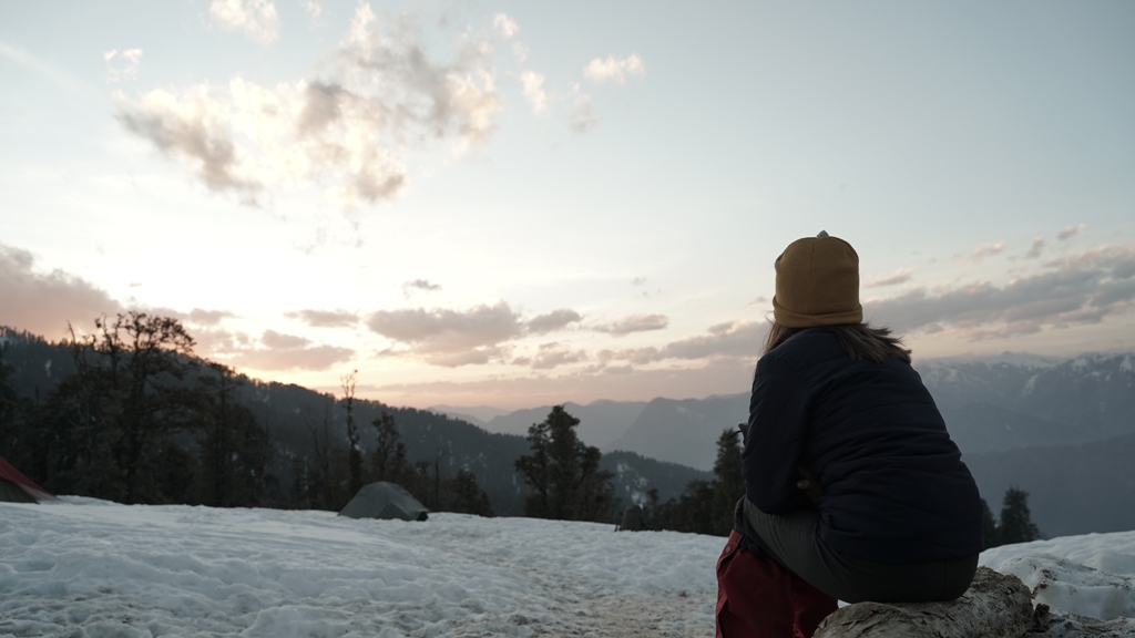 trekker watching the sunset in himalayas