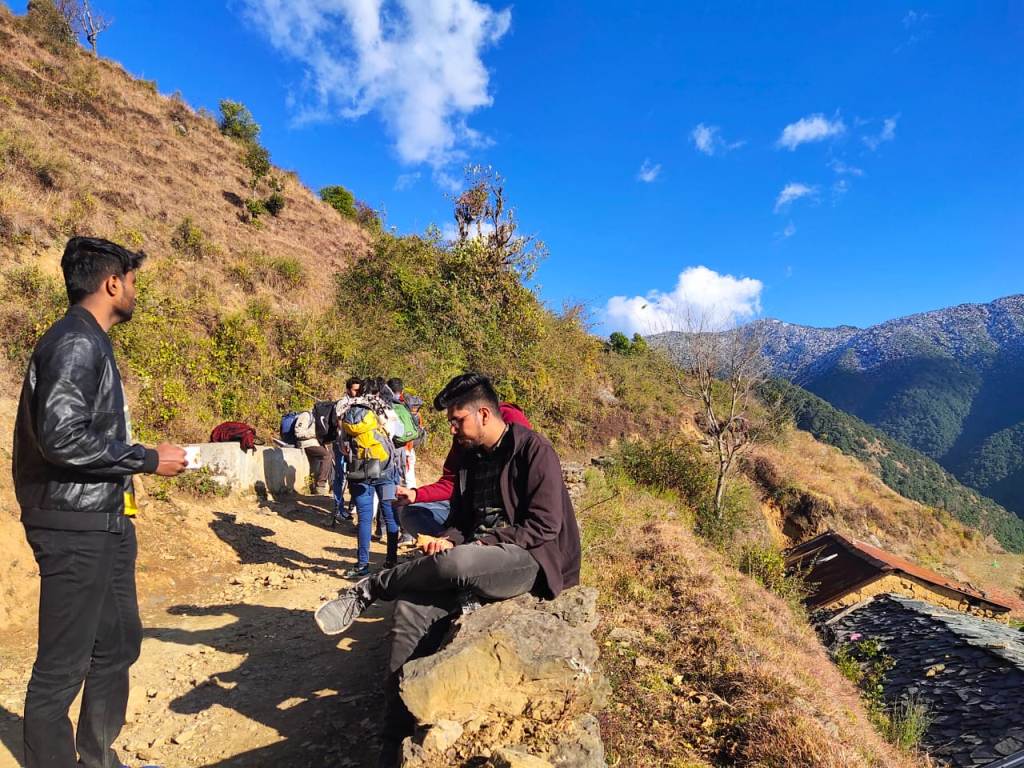 trekkers taking rest enroute nag tibba