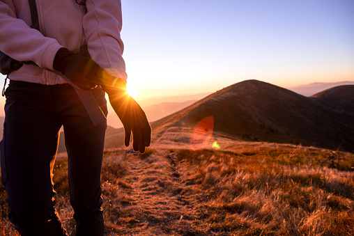 Trekker wearing hiking gloves