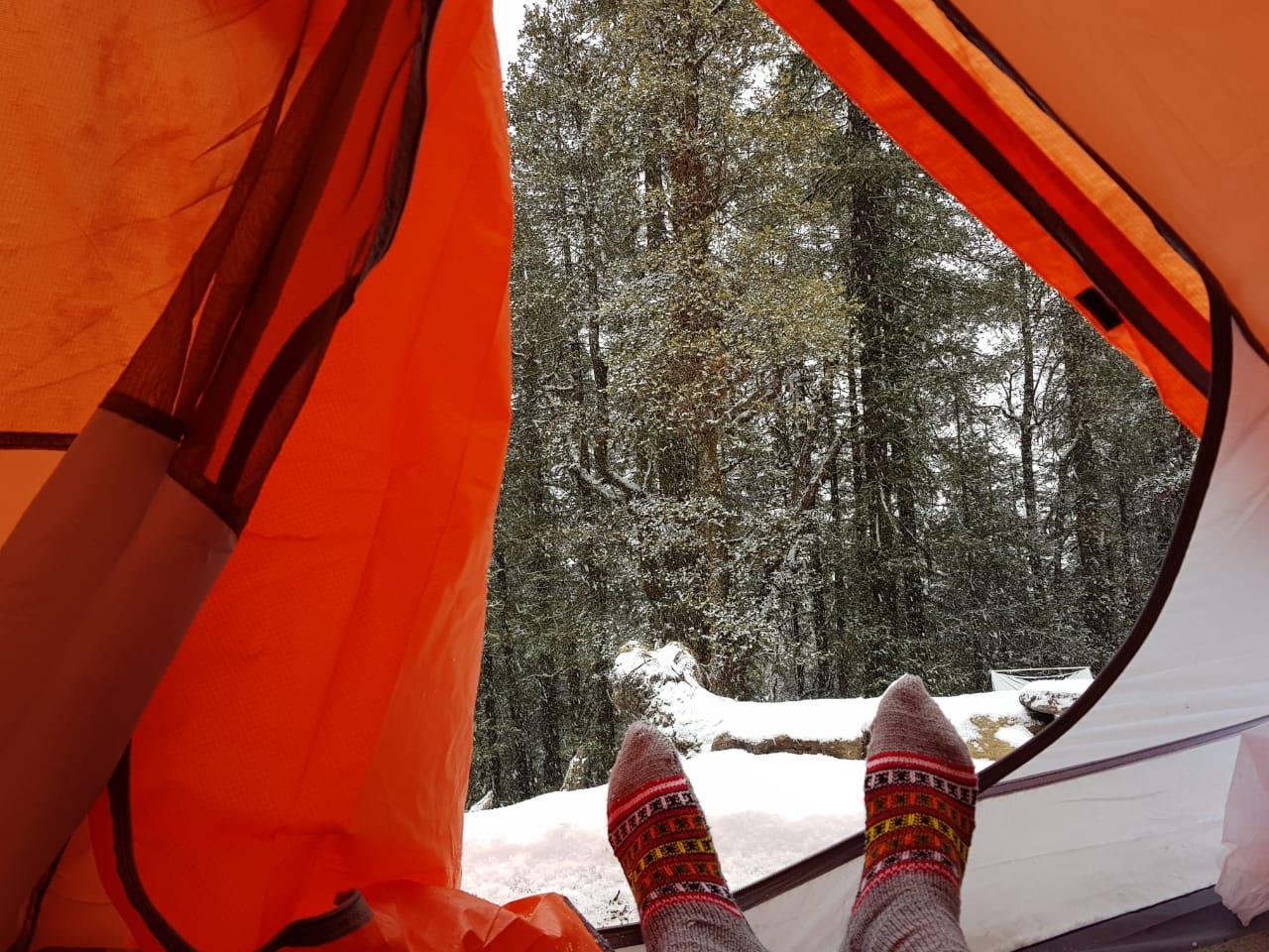 camping in snow with proper clothing to keep you warm